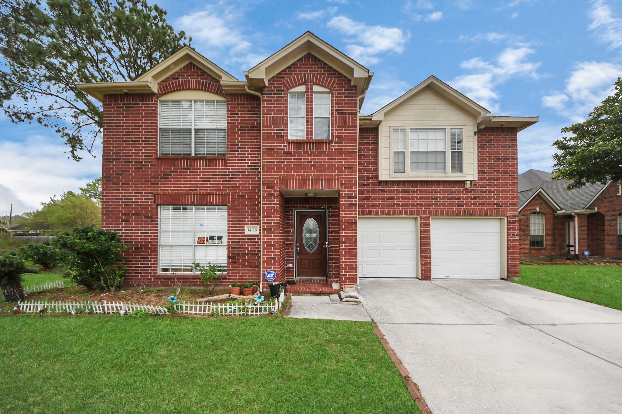 14119 Renn Road Houston, TX 77083 - Photo 39 of 43 a front view of a house with a yard and garage