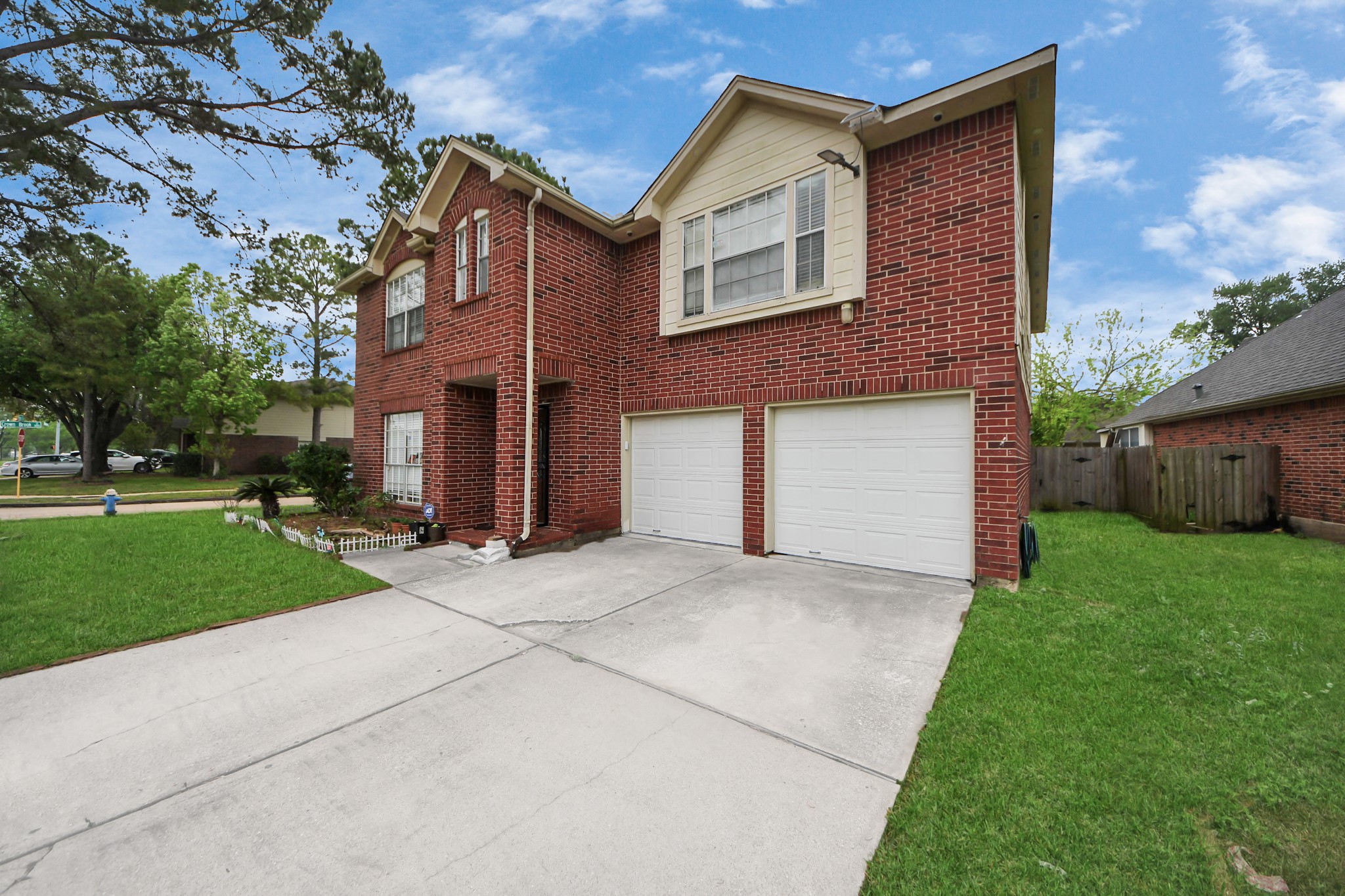 14119 Renn Road Houston, TX 77083 - Photo 40 of 43 a front view of a house with a yard and garage