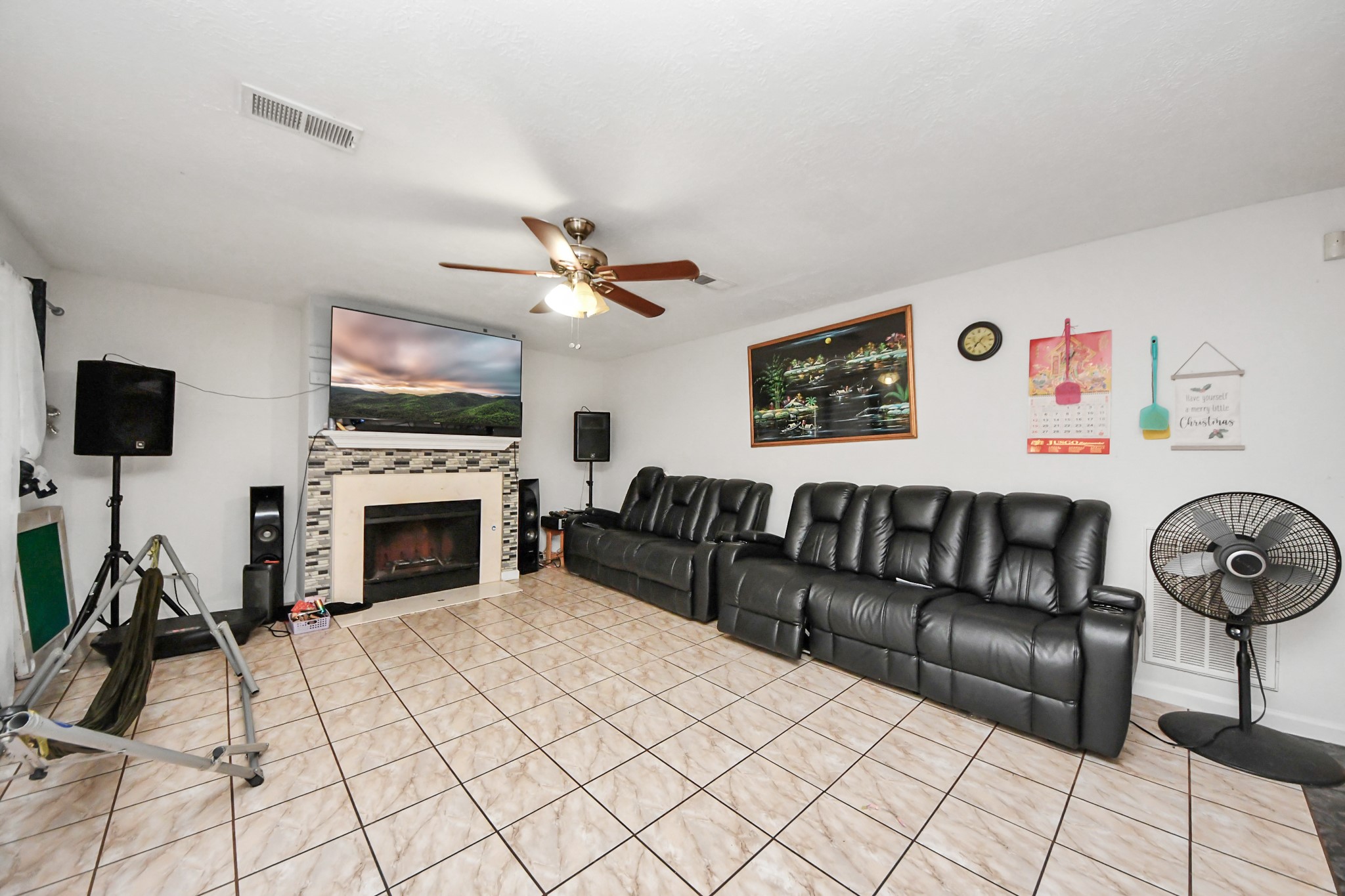 14119 Renn Road Houston, TX 77083 - Photo 4 of 43 a living room with furniture a flat screen tv and a fireplace