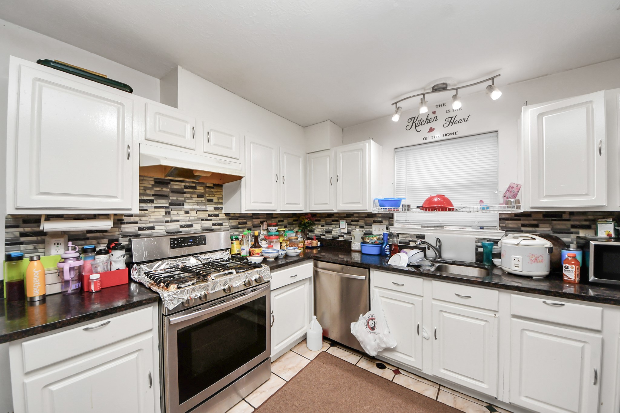 14119 Renn Road Houston, TX 77083 - Photo 8 of 43 a kitchen with cabinets appliances and a counter top space