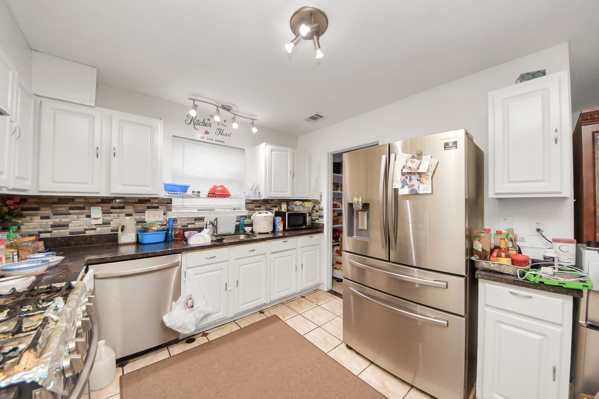 14119 Renn Road Houston, TX 77083 - Photo 9 of 43 a kitchen with stainless steel appliances granite countertop a refrigerator sink and cabinets