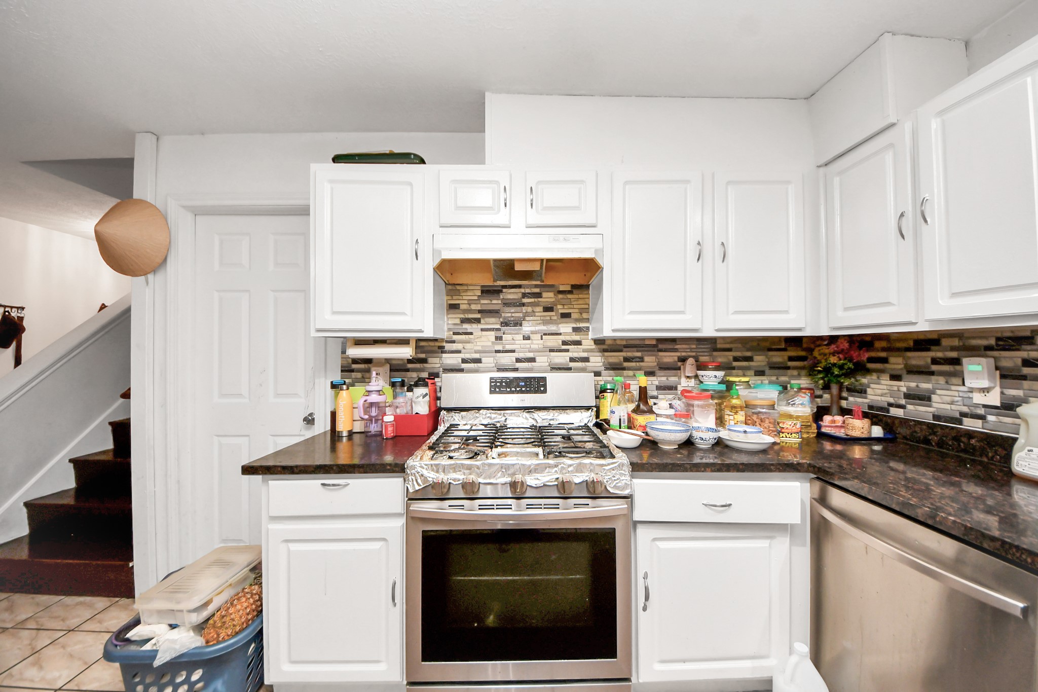 14119 Renn Road Houston, TX 77083 - Photo 10 of 43 a kitchen with stainless steel appliances granite countertop a stove and cabinets