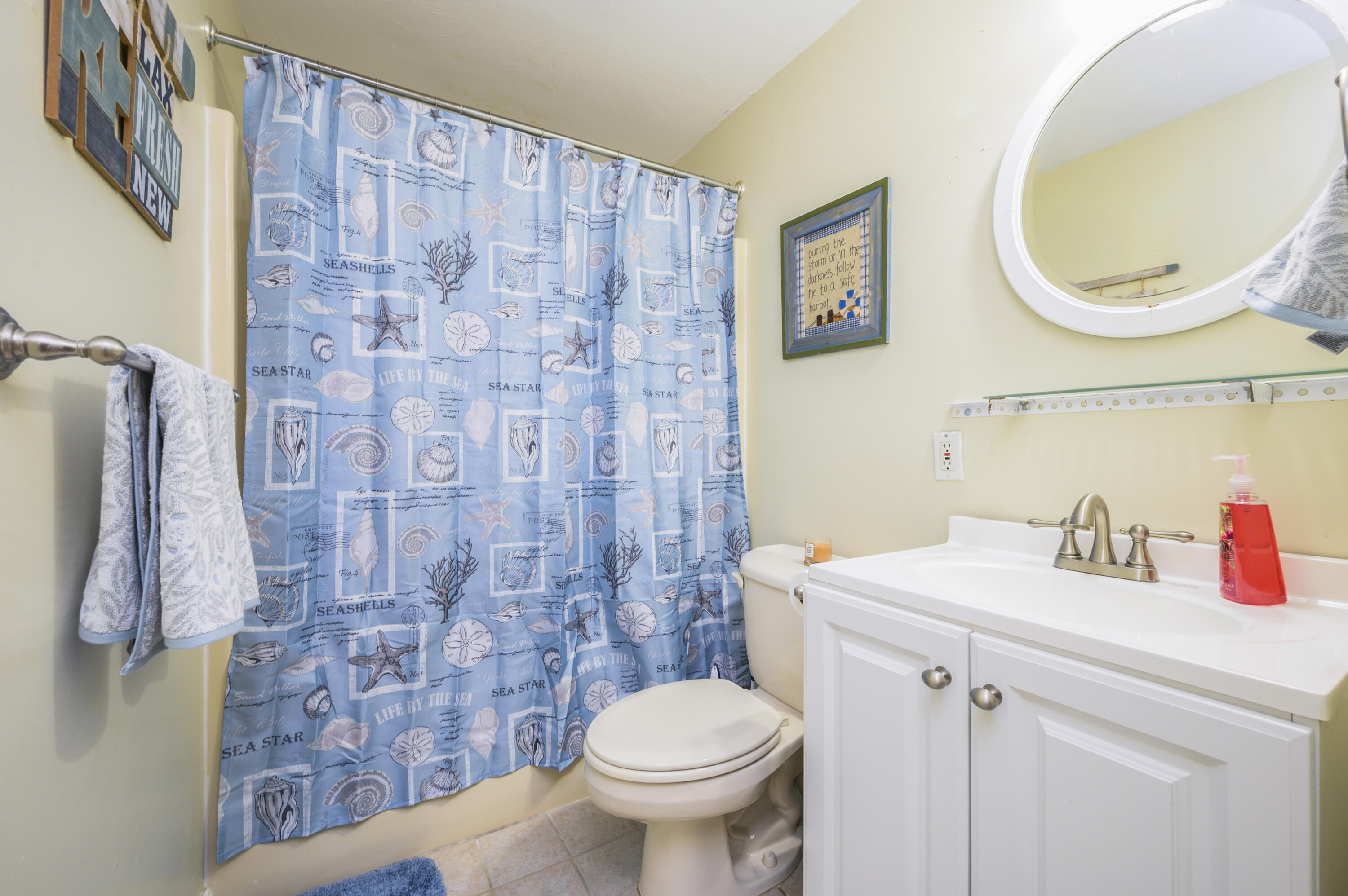 52 Zeno Crocker Road Centerville, MA 02632 - Photo 13 of 20 a bathroom with a sink a toilet and a mirror