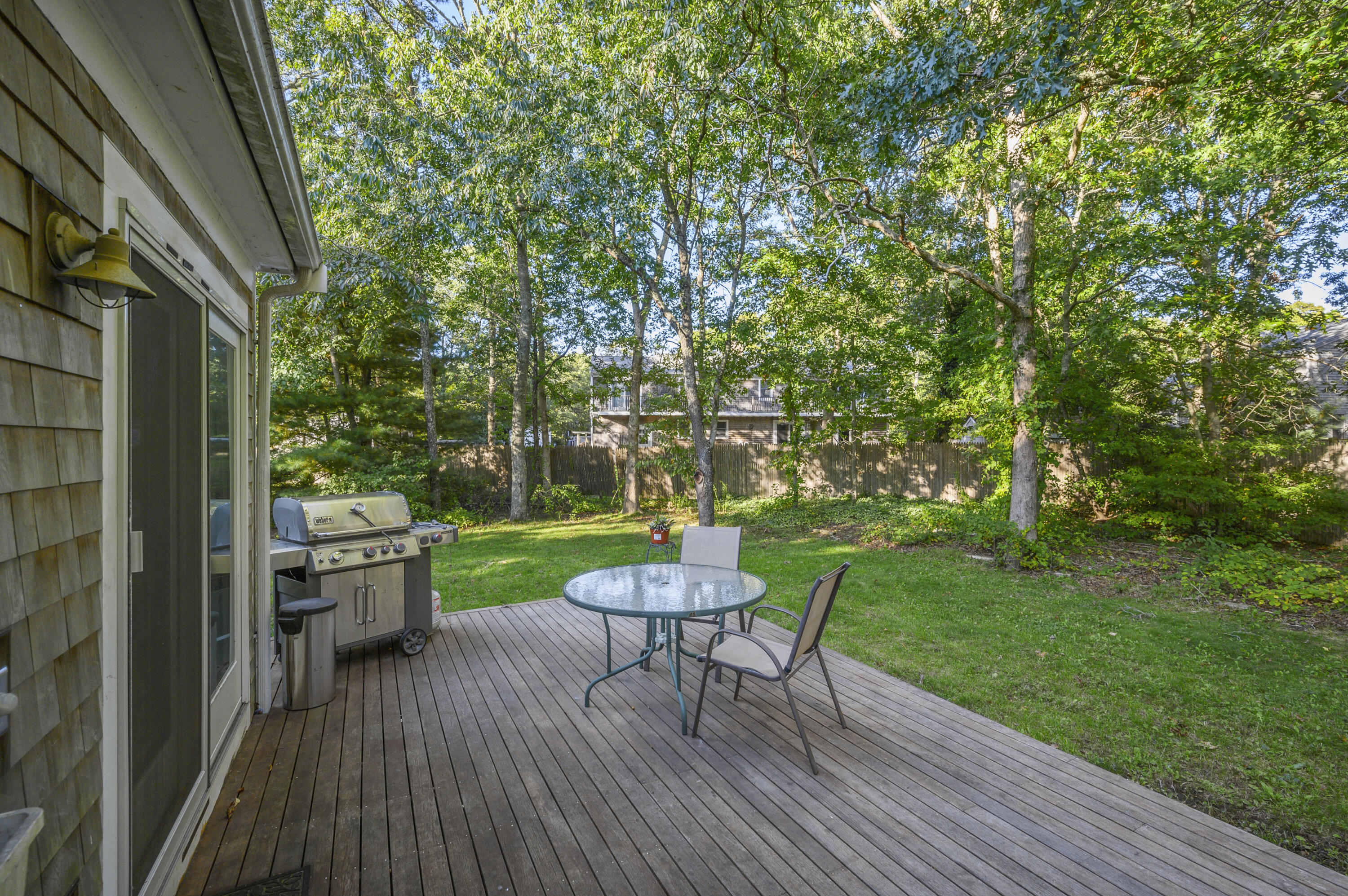 52 Zeno Crocker Road Centerville, MA 02632 - Photo 18 of 20 a view of a chair and table in backyard of the house