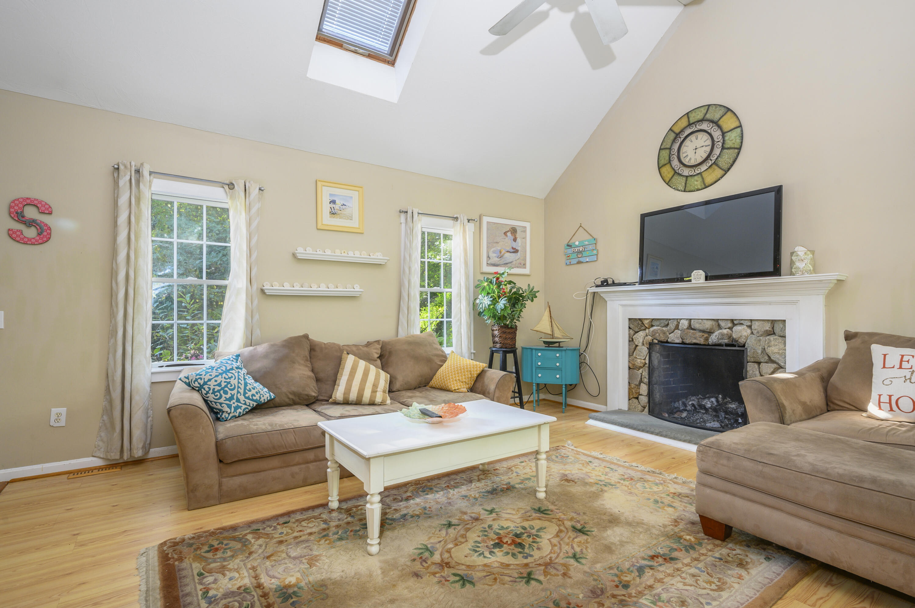 52 Zeno Crocker Road Centerville, MA 02632 - Photo 4 of 20 a living room with furniture a fireplace and a flat screen tv