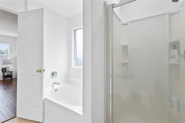 a spacious bedroom with a bed and a couch