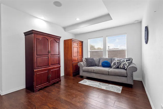 a bedroom with furniture and a flat screen tv