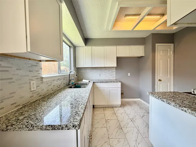 a kitchen with a sink and a stove