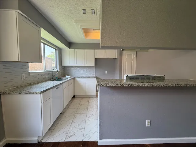 a kitchen with a sink and cabinets