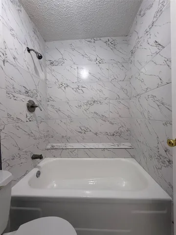 a bathroom with a bathtub and shower