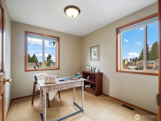 a bathroom with a toilet a sink a tub and mirror