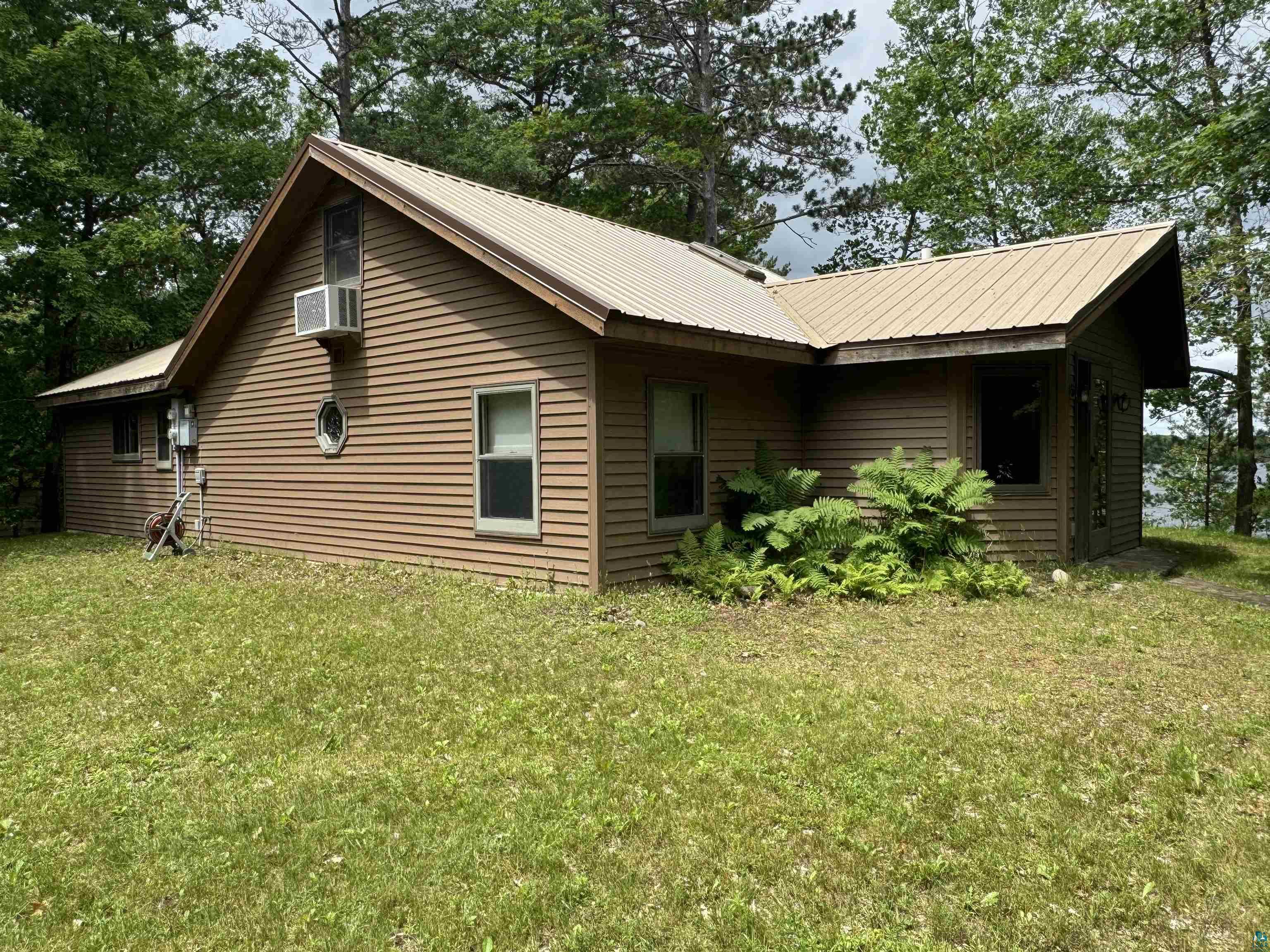 10690 Cedar Crest Road Iron River, WI 54847 - Photo 1 of 24 View of front of property featuring a yard