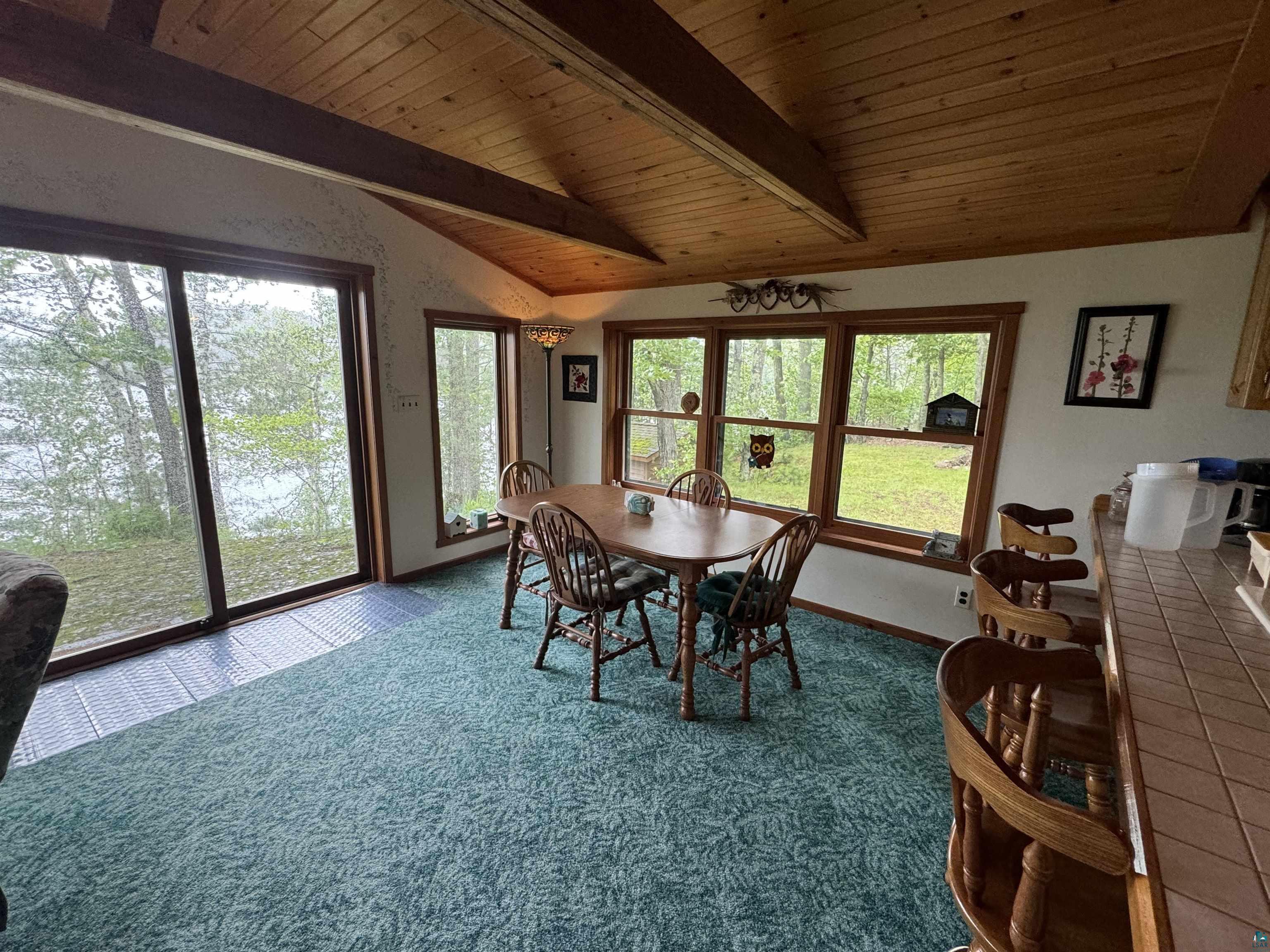 10690 Cedar Crest Road Iron River, WI 54847 - Photo 7 of 24 dining room with wood ceiling, plenty of natural light, and vaulted ceiling with beams