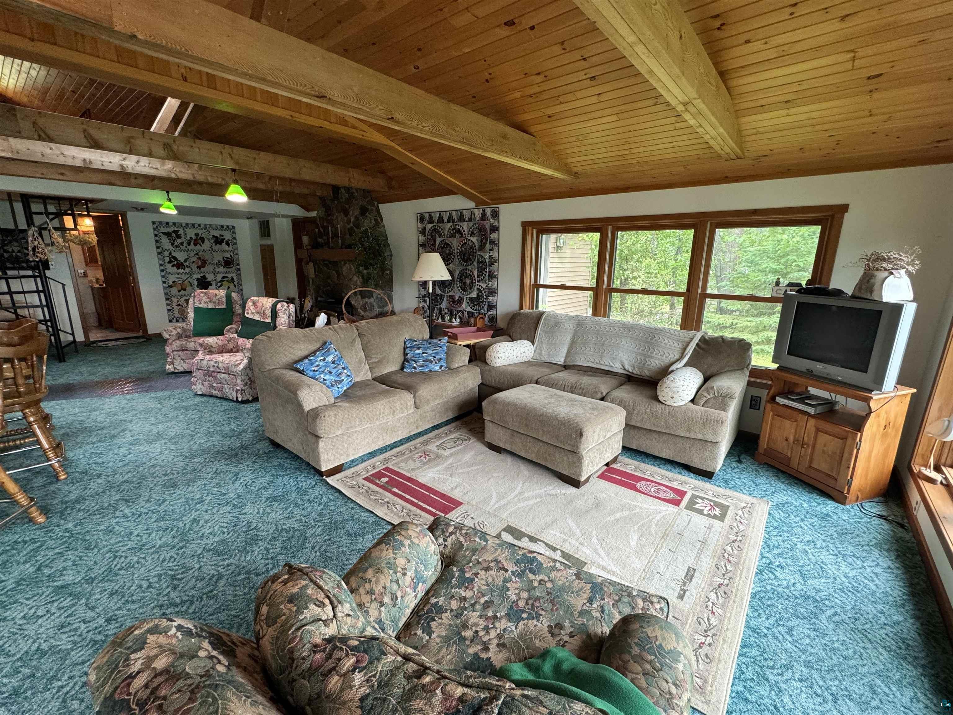10690 Cedar Crest Road Iron River, WI 54847 - Photo 8 of 24 Carpeted living room featuring wooden ceiling and vaulted ceiling with beams