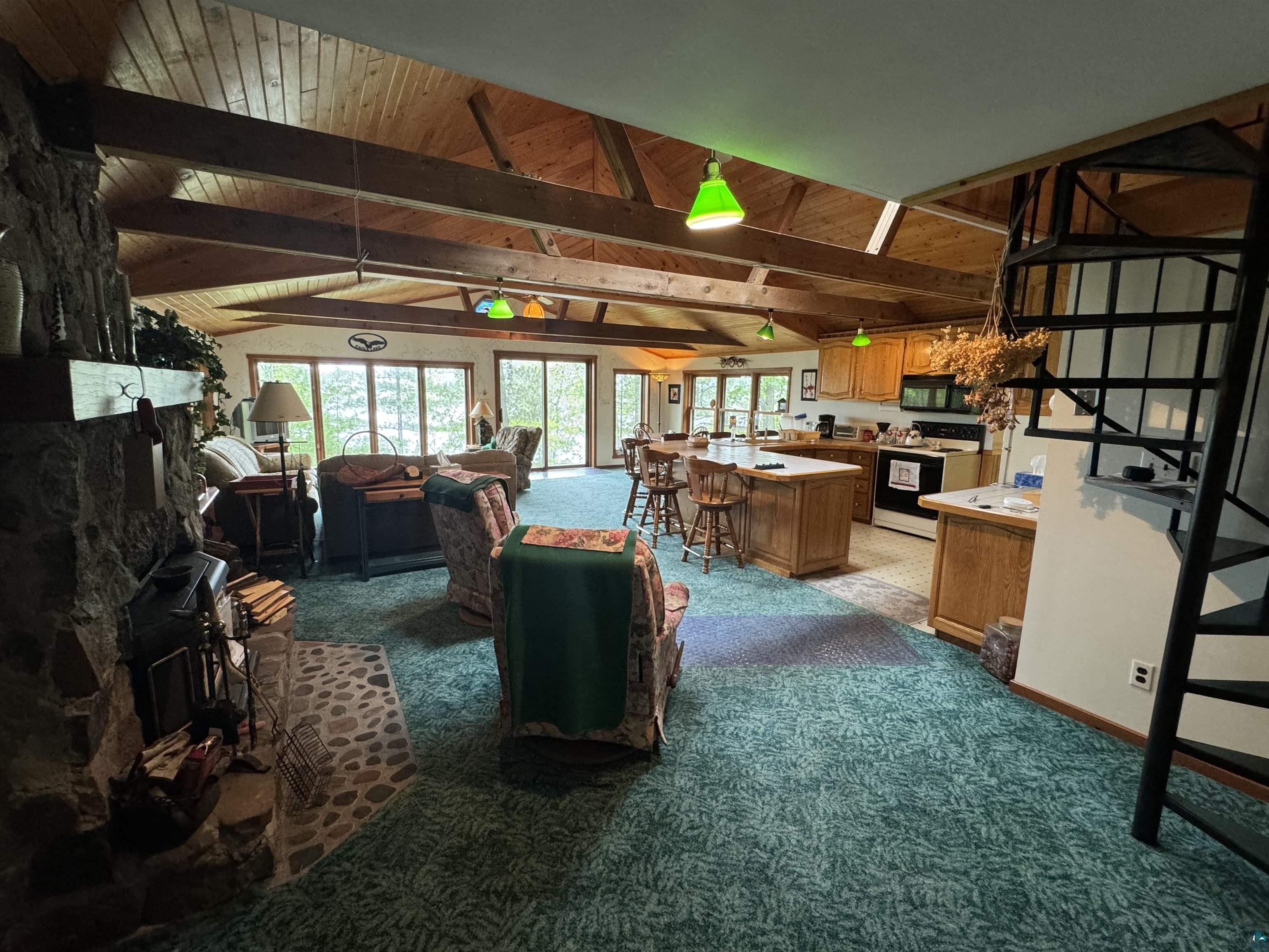 10690 Cedar Crest Road Iron River, WI 54847 - Photo 9 of 24 Interior space with lofted ceiling with beams, range with electric stovetop, carpet floors, and wood ceiling