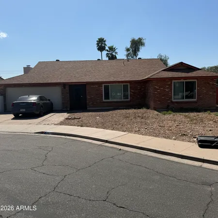 a house that has a tree in front of it