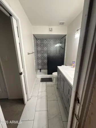 a view of bathroom with a sink and a mirror