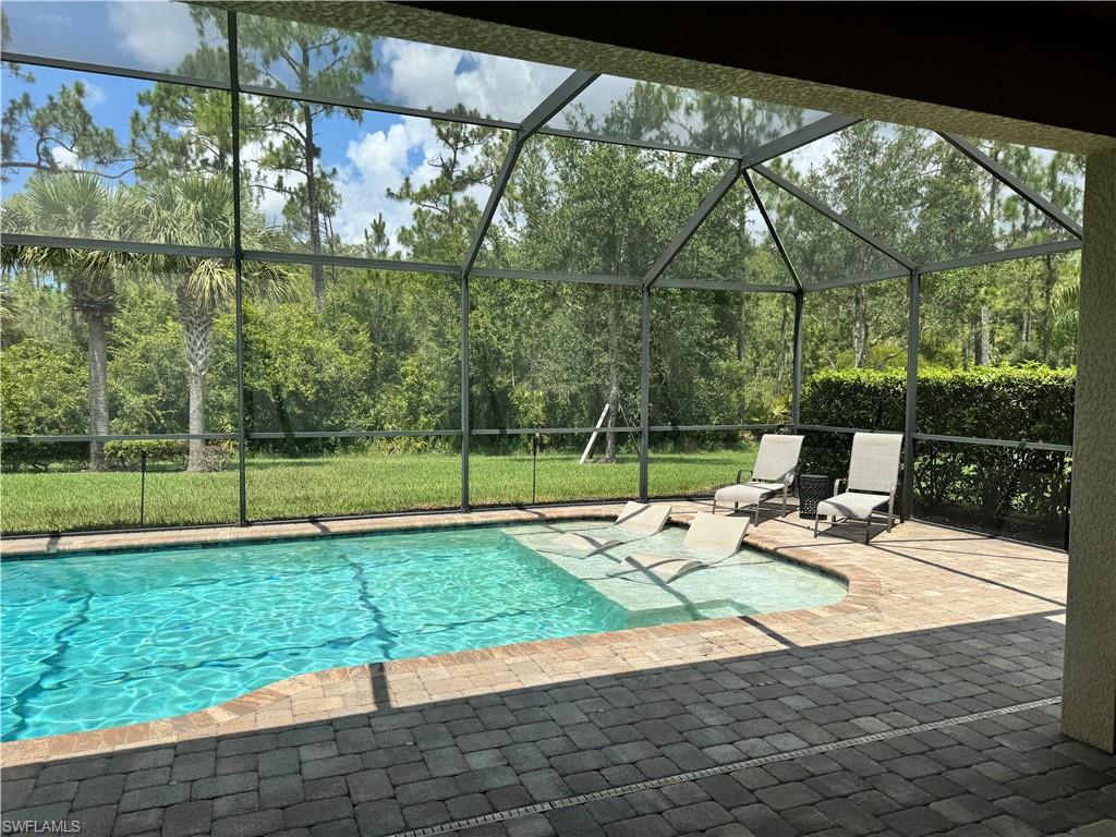 10840 Rutherford Road Fort Myers, FL 33913 - Photo 25 of 35 View of pool featuring a patio and glass enclosure