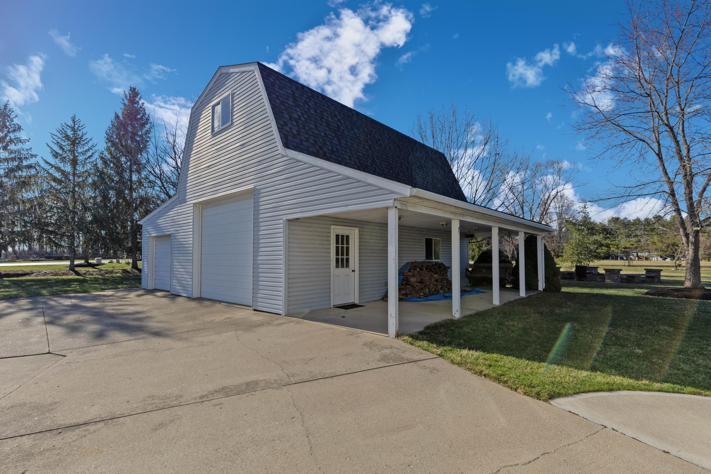 1364 Dale Ford Road Delaware, OH 43015 - Photo 84 of 112 • Vinyl exterior • Lean-to with concrete flooring • Concrete floor • Finished walls • (2) mini splits • Interior speakers • Insulated door • Man door • Shared driveway sealed ~ 2024 • 200 amp panel • Garage keyless entry keypad • Shop equipment does not remain • Dust collection pipes remain