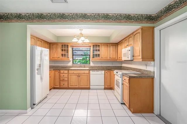 a kitchen with stainless steel appliances granite countertop a sink and cabinets