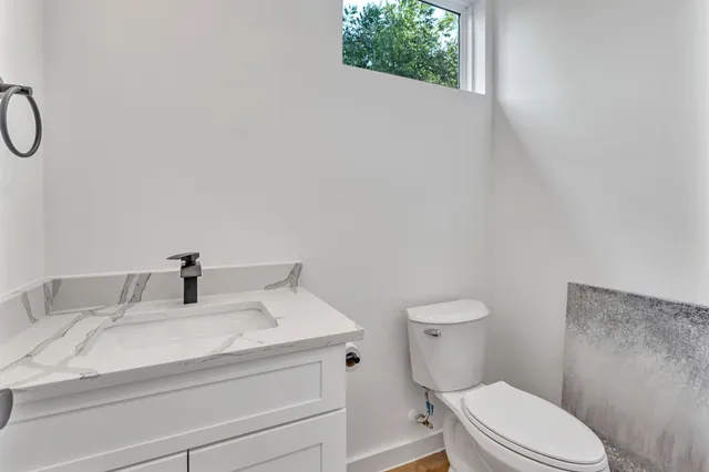 a view of a room with furniture and wooden floor