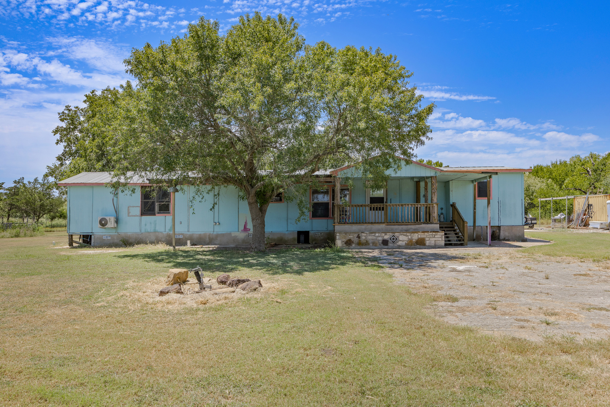 147 Community Center Road Rosanky, TX 78953 - Photo 4 of 33 Back of house featuring a porch and a yard