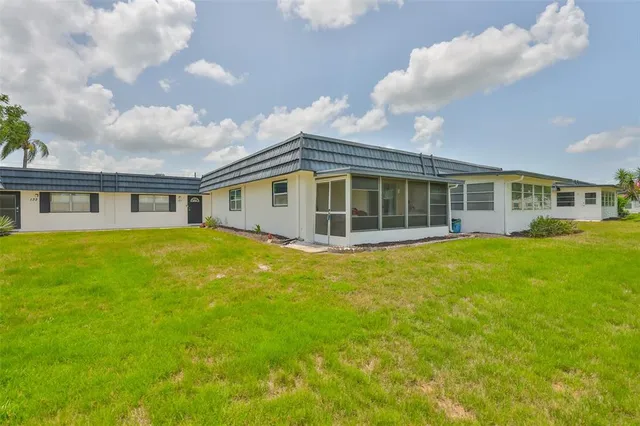 a view of a house with a backyard