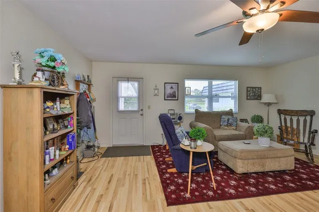 a living room with furniture and a book shelf