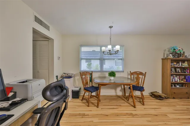 a view of a dining room with furniture a rug and wooden floor