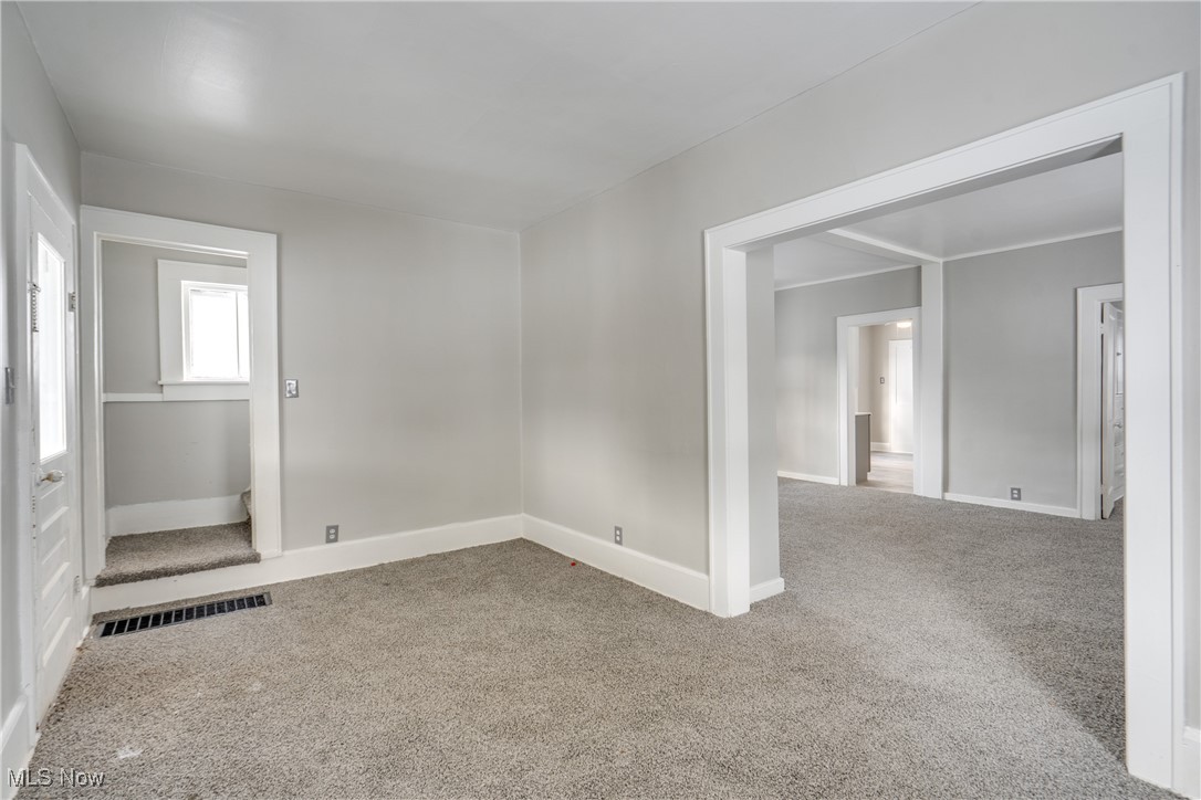 46 Rosenberry Street Alliance, OH 44601 - Photo 7 of 39 Empty room featuring light carpet and baseboards