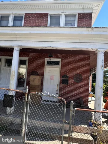 a front view of a house with chairs