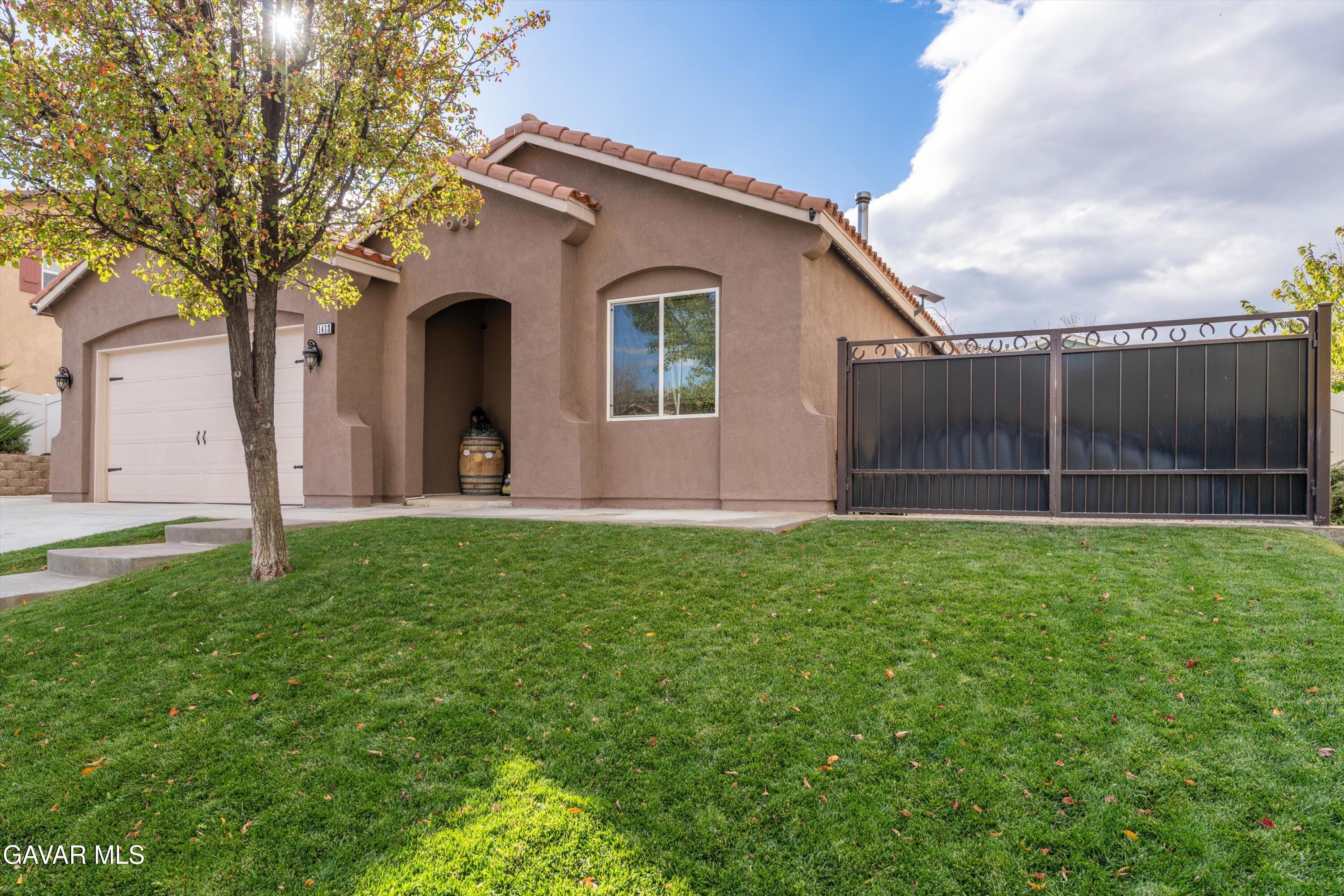 1413 Wild Olive Road Tehachapi, CA 93561 - Photo 18 of 29 a view of a backyard with potted plants and large tree