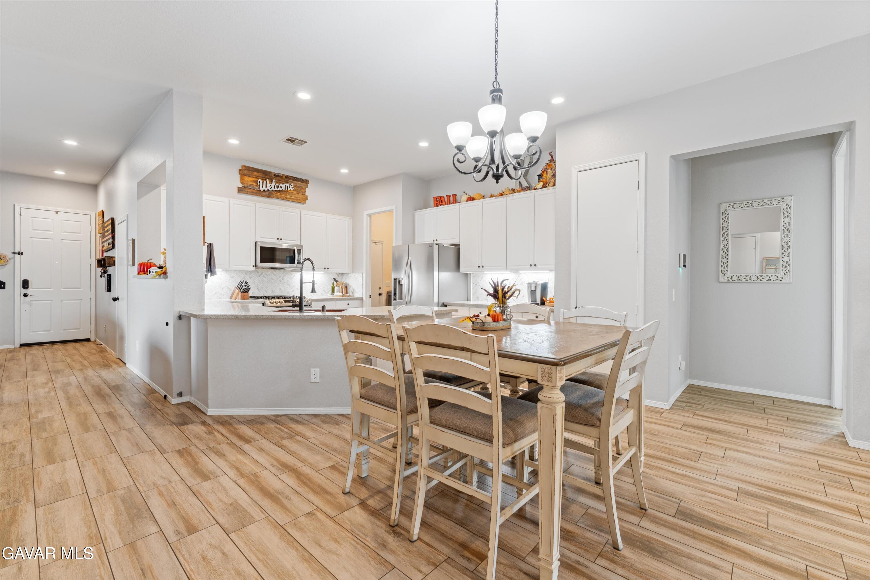 1413 Wild Olive Road Tehachapi, CA 93561 - Photo 22 of 29 a view of a dining room with furniture wooden floor and chandelier