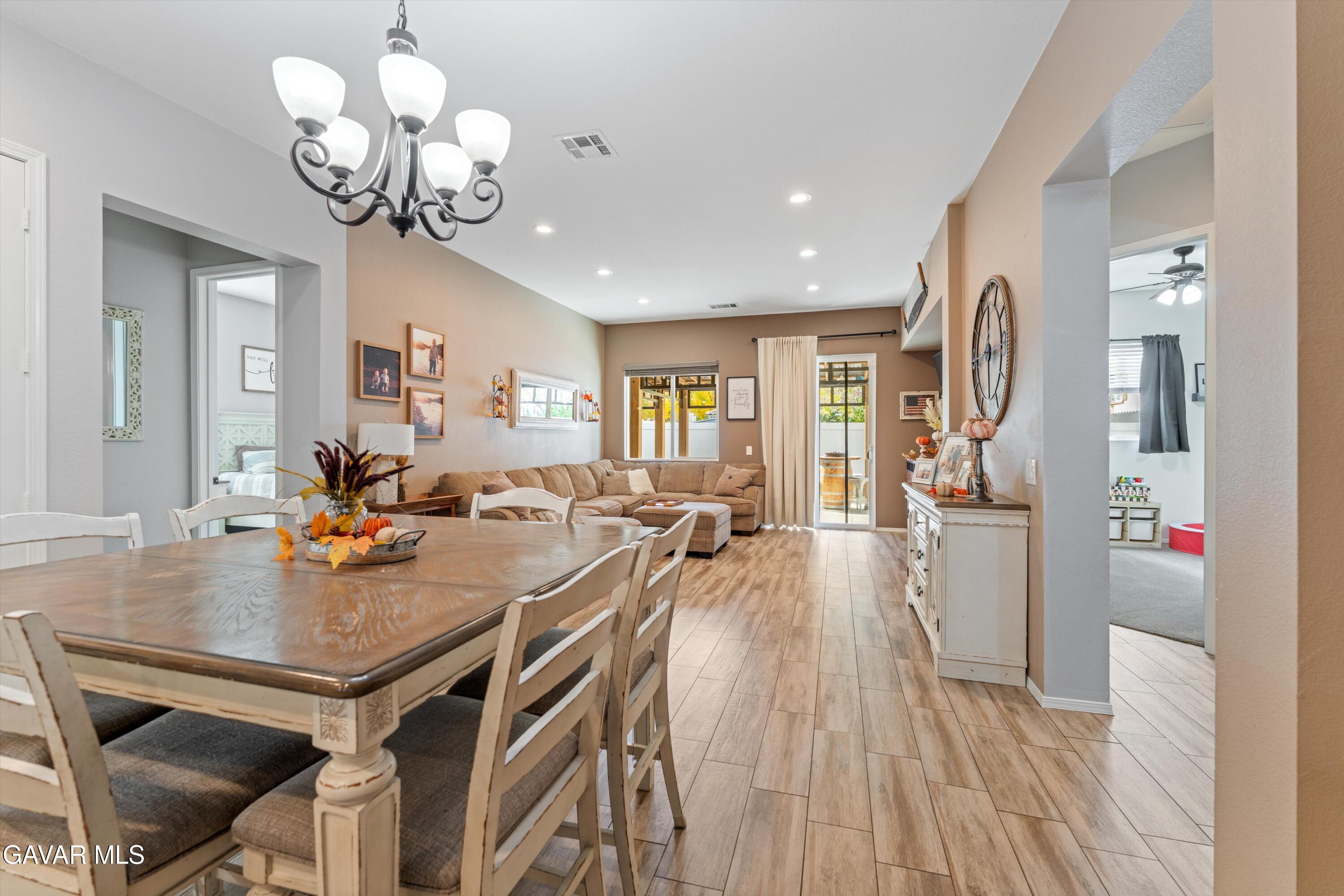 1413 Wild Olive Road Tehachapi, CA 93561 - Photo 25 of 29 a view of a dining room and livingroom with furniture wooden floor a chandelier