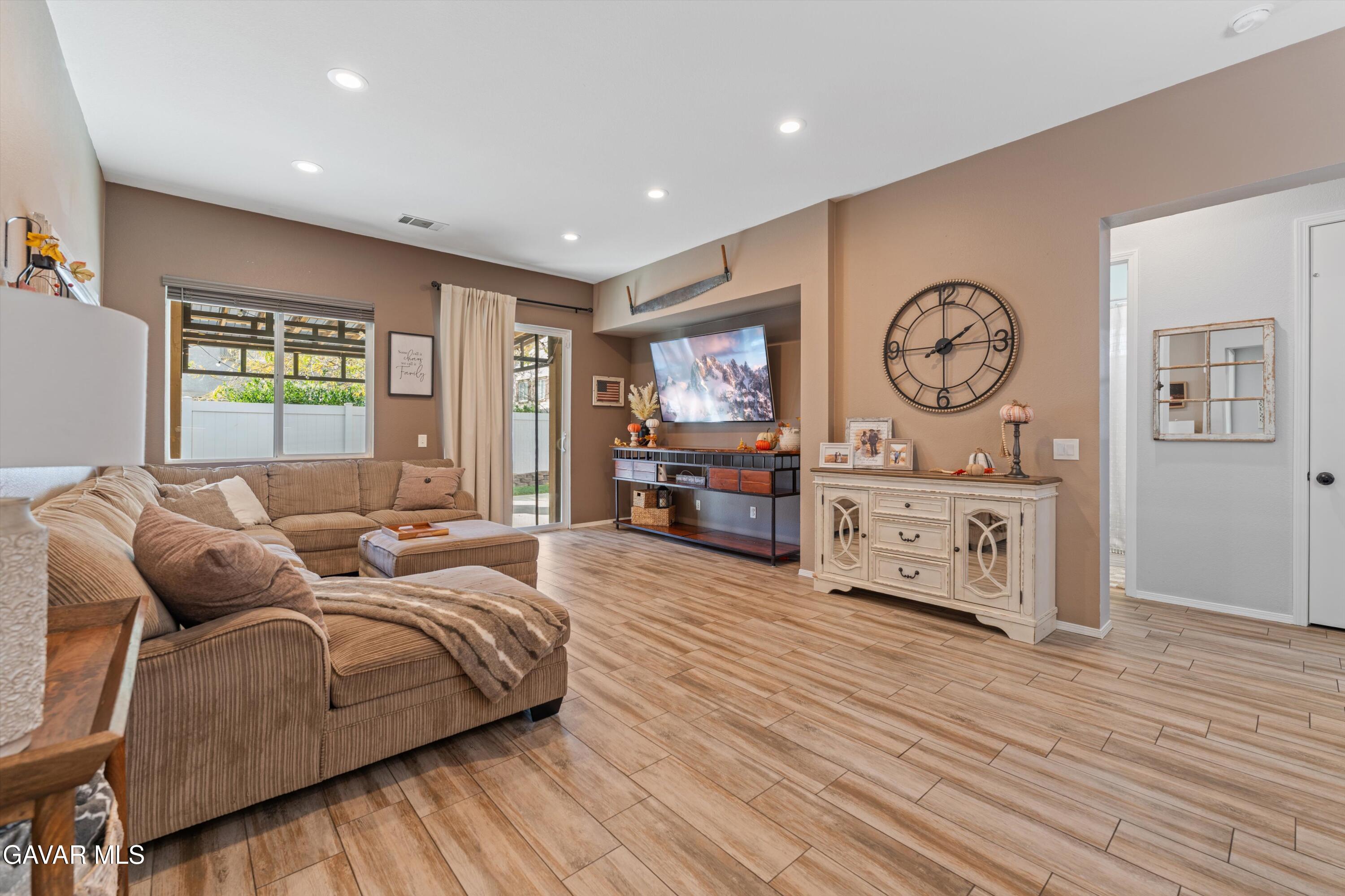 1413 Wild Olive Road Tehachapi, CA 93561 - Photo 26 of 29 a living room with furniture a window and a clock
