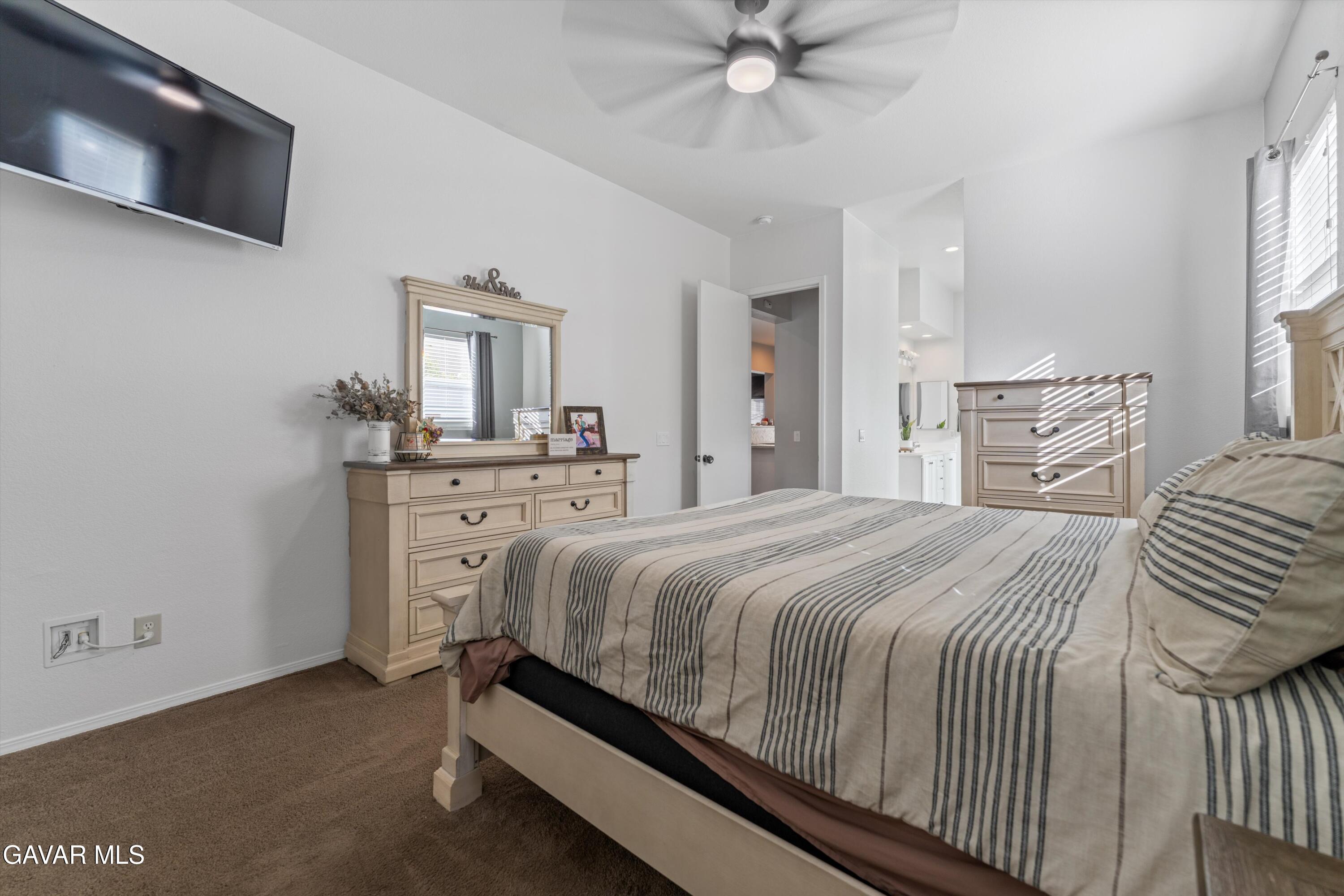 1413 Wild Olive Road Tehachapi, CA 93561 - Photo 28 of 29 a bedroom with a bed and a flat screen tv