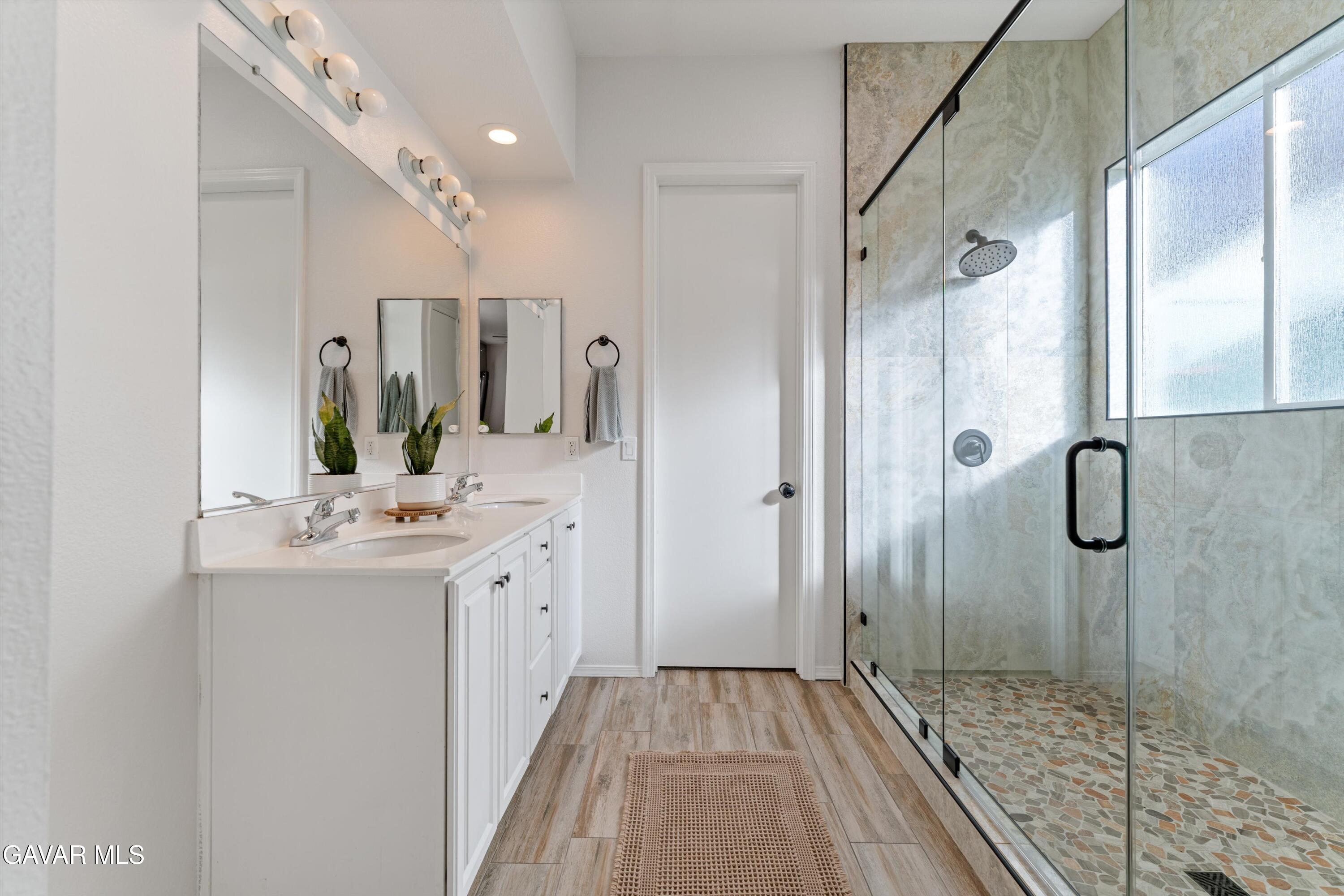 1413 Wild Olive Road Tehachapi, CA 93561 - Photo 29 of 29 a bathroom with a sink a mirror and shower