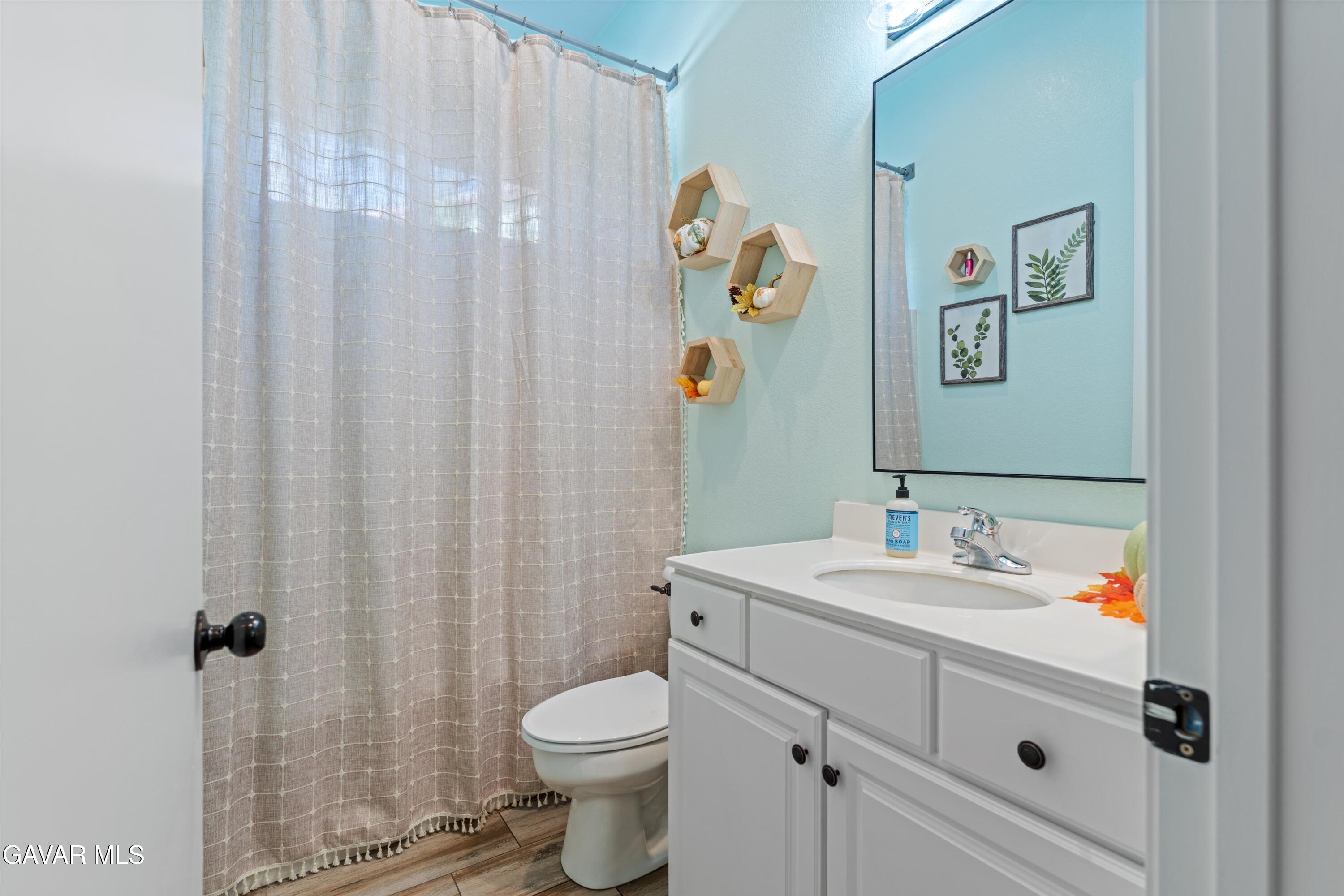 1413 Wild Olive Road Tehachapi, CA 93561 - Photo 3 of 29 a bathroom with a sink mirror vanity and toilet