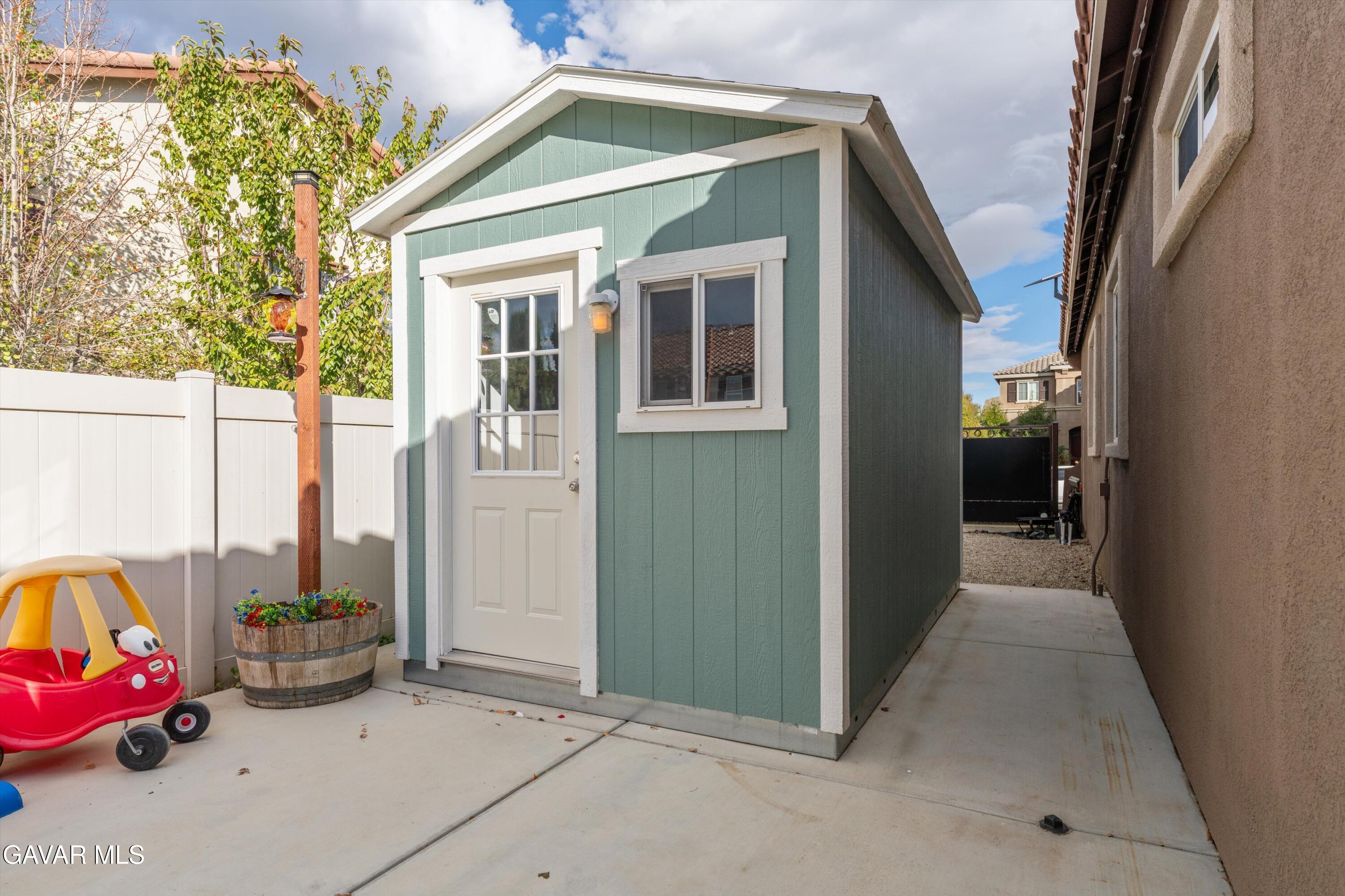 1413 Wild Olive Road Tehachapi, CA 93561 - Photo 9 of 29 a view of a house with a cars park side of a road