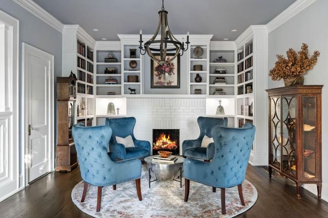 a living room with furniture and a chandelier
