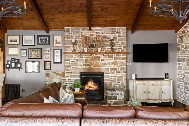 a living room with furniture a flat screen tv and a fireplace
