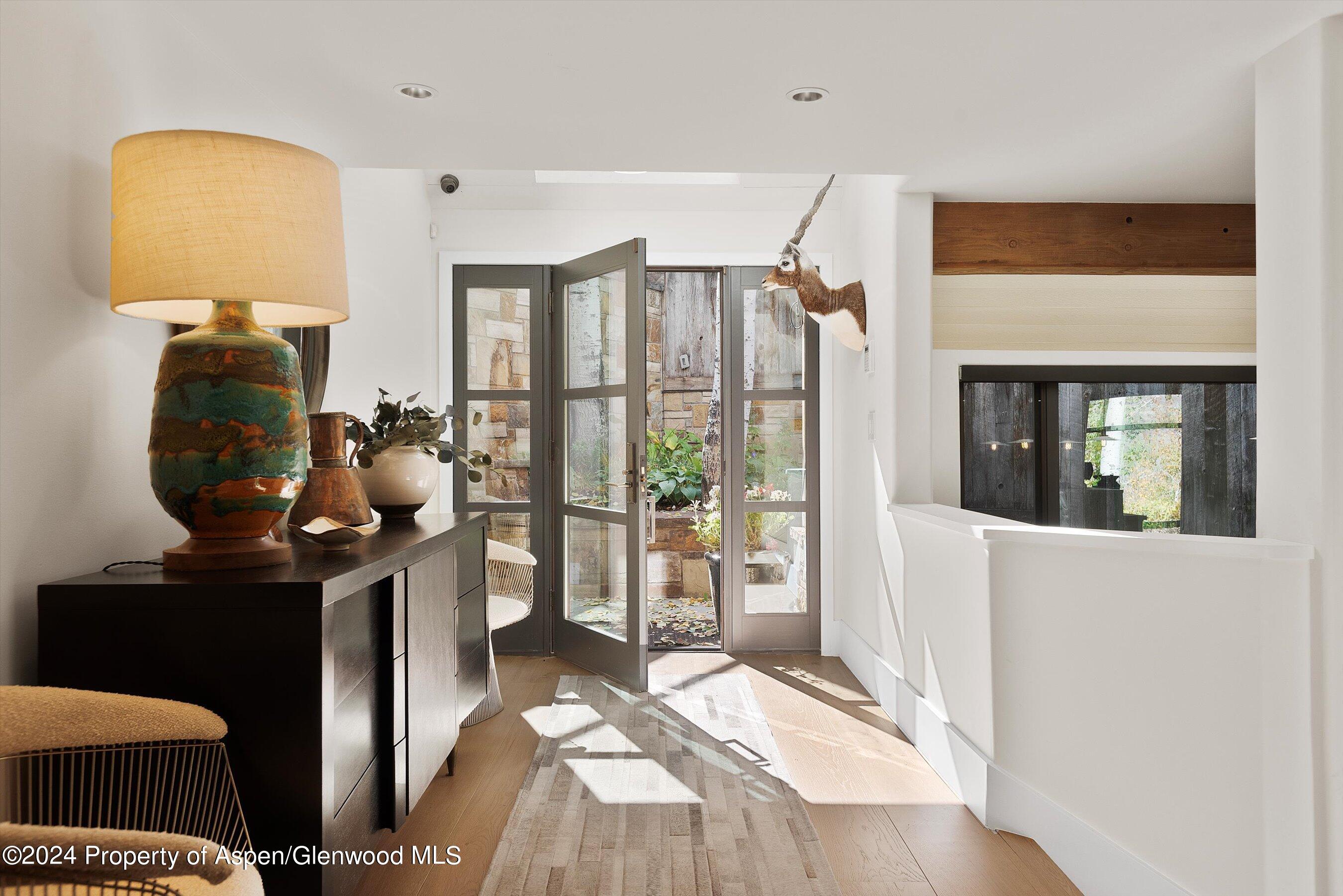 234 Bridge Lane Snowmass Village, CO 81615 - Photo 13 of 46 a bedroom with a bed and wooden floor
