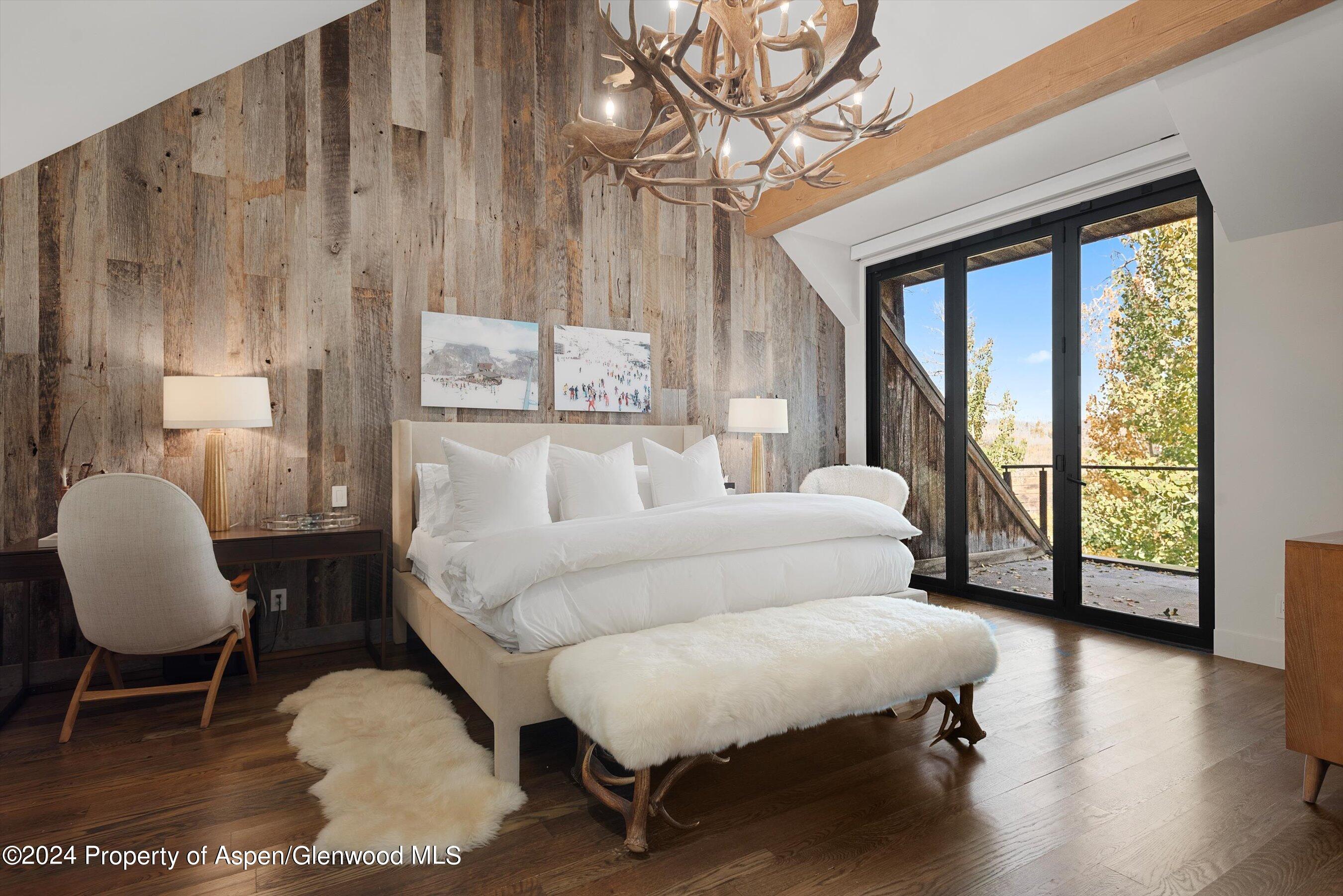 234 Bridge Lane Snowmass Village, CO 81615 - Photo 14 of 46 a bed room with a bed and a chair