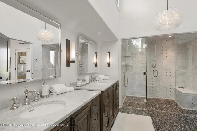 a spacious bathroom with a shower sink and mirror
