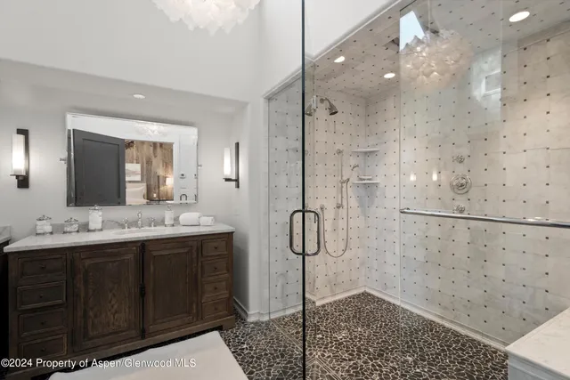 a bathroom with a double vanity sink mirror and shower
