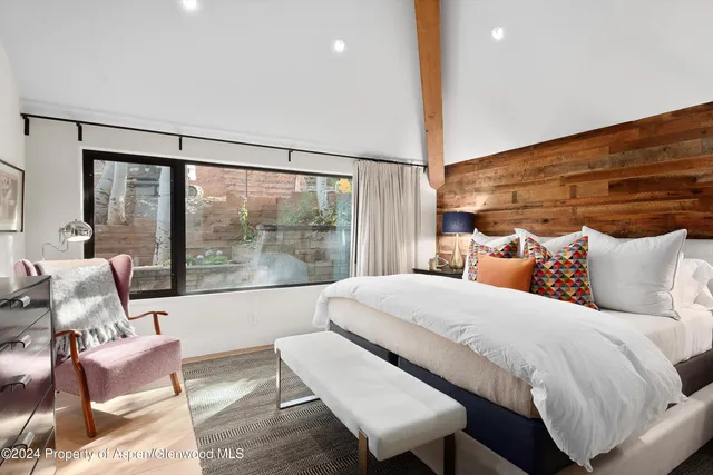 a bathroom with a granite countertop sink a toilet a mirror and shower