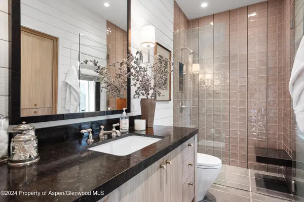 a large bed sitting in a bedroom next to a window