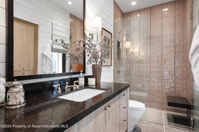 a large bed sitting in a bedroom next to a window