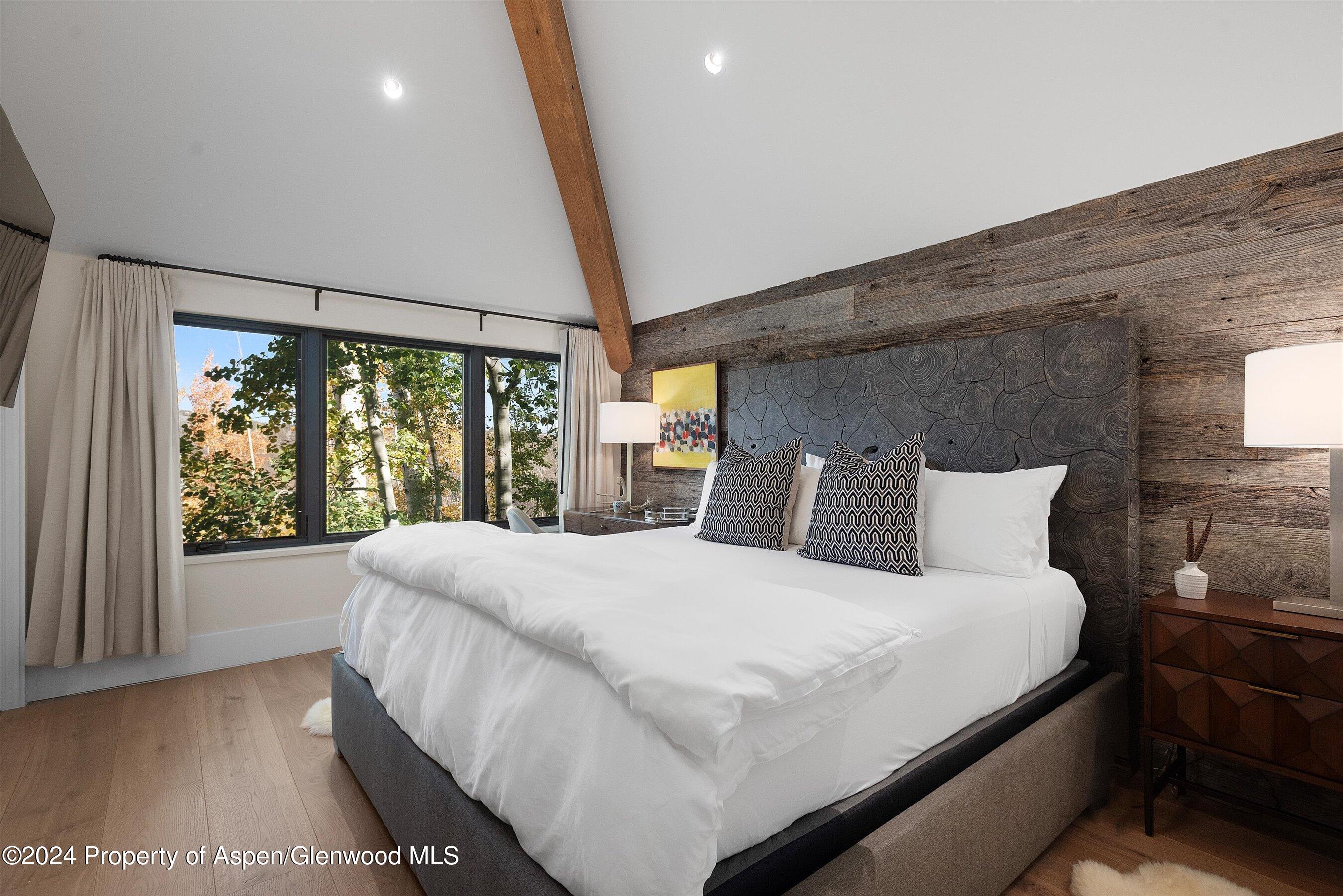 234 Bridge Lane Snowmass Village, CO 81615 - Photo 21 of 46 a large bed sitting in a bedroom next to a window
