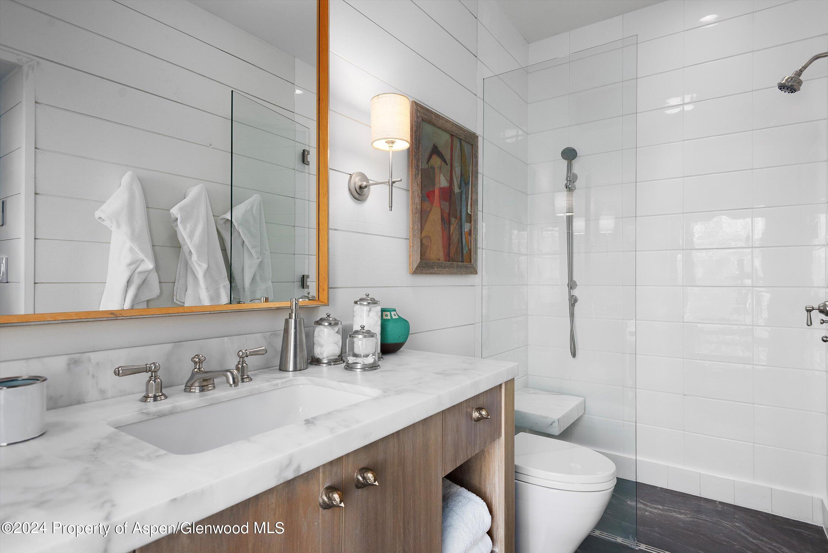 234 Bridge Lane Snowmass Village, CO 81615 - Photo 24 of 46 a bathroom with a granite countertop sink toilet and shower